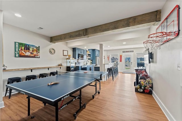 game room featuring visible vents, baseboards, recessed lighting, beamed ceiling, and light wood-type flooring