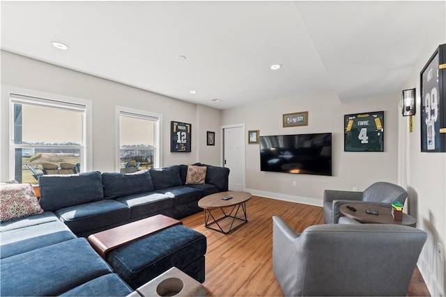 living room with recessed lighting, baseboards, and light wood finished floors