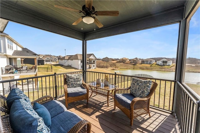 wooden deck with a residential view, an outdoor living space, a ceiling fan, and a water view