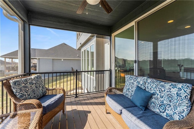 sunroom featuring a ceiling fan