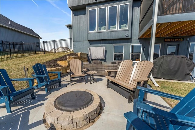 view of patio / terrace with grilling area, a fire pit, and fence