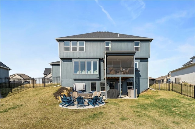 back of house featuring a patio area, a lawn, and a fenced backyard