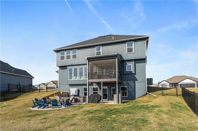 rear view of property featuring a sunroom, a patio area, a lawn, and a fenced backyard