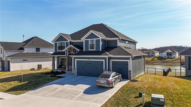 view of front facade with driveway, fence, board and batten siding, a front yard, and an attached garage