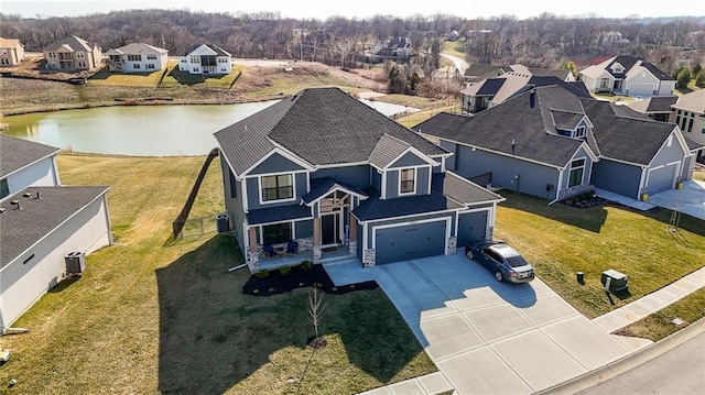 drone / aerial view with a residential view and a water view