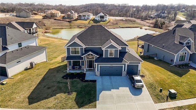 drone / aerial view with a water view and a residential view