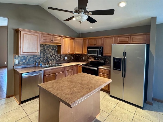 kitchen with tasteful backsplash, light tile patterned floors, appliances with stainless steel finishes, and a sink