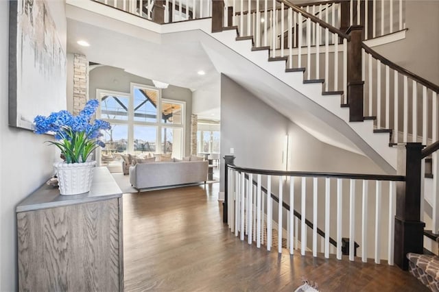 16121 Paradise St, Overland Park, KS 66221 - staircase with a high ceiling, wood finished floors, and recessed lighting