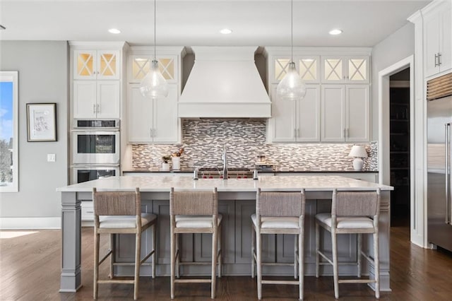 16121 Paradise St, Overland Park, KS 66221 - kitchen with premium range hood, dark wood-style flooring, tasteful backsplash, stainless steel appliances, and recessed lighting