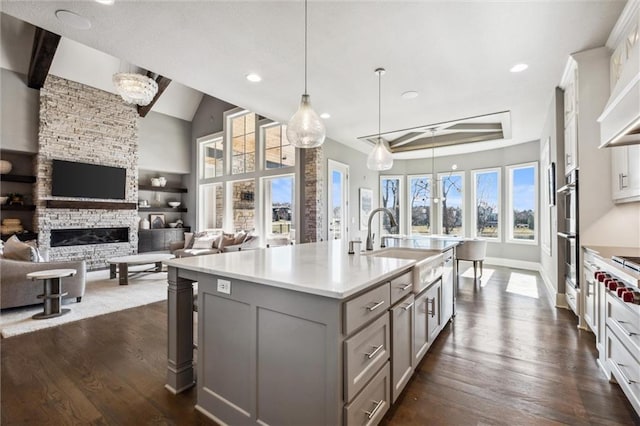 16121 Paradise St, Overland Park, KS 66221 - kitchen with gray cabinets, dark wood-style flooring, light countertops, recessed lighting, and stainless steel appliances