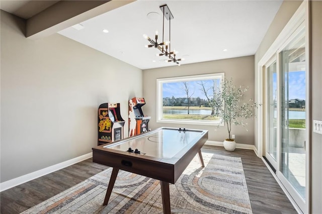 16121 Paradise St, Overland Park, KS 66221 - recreation room with wood finished floors, a chandelier, recessed lighting, and a water view
