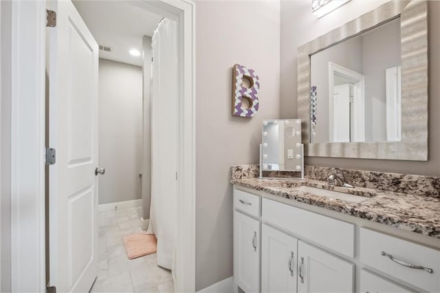 16121 Paradise St, Overland Park, KS 66221 - bathroom featuring vanity, marble look tile flooring, and recessed lighting