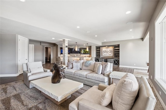 16121 Paradise St, Overland Park, KS 66221 - living area featuring ornate columns, wood finished floors, recessed lighting, and bar