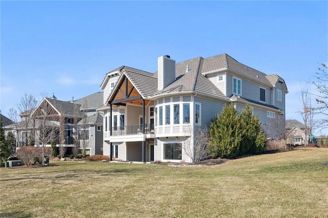 16121 Paradise St, Overland Park, KS 66221 - rear view of house featuring a balcony, a yard, and a chimney