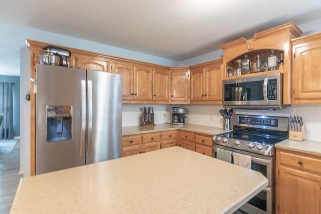kitchen with light countertops and appliances with stainless steel finishes