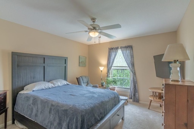 bedroom with baseboards, ceiling fan, and light carpet