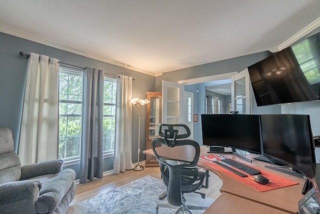 office area with baseboards, ornamental molding, and light wood-style flooring