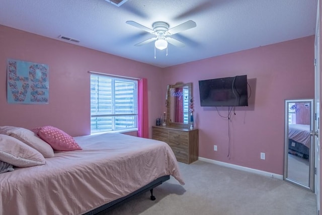 carpeted bedroom featuring a ceiling fan, baseboards, and visible vents