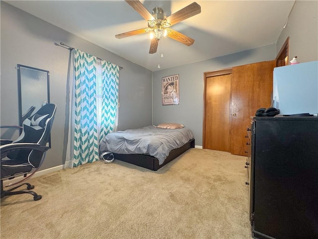 carpeted bedroom with baseboards, a closet, and ceiling fan