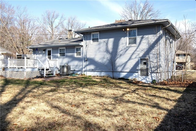 back of house featuring cooling unit, fence, a chimney, a deck, and a lawn