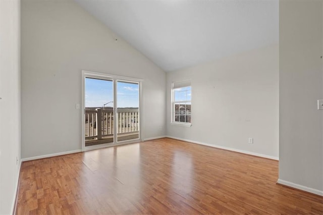 5501 NE 80th Ter Unit 3A, Kansas City, MO 64119 - empty room featuring baseboards, high vaulted ceiling, and wood finished floors