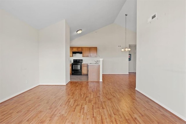 5501 NE 80th Ter Unit 3A, Kansas City, MO 64119 - unfurnished living room featuring high vaulted ceiling, an inviting chandelier, baseboards, and light wood-style floors