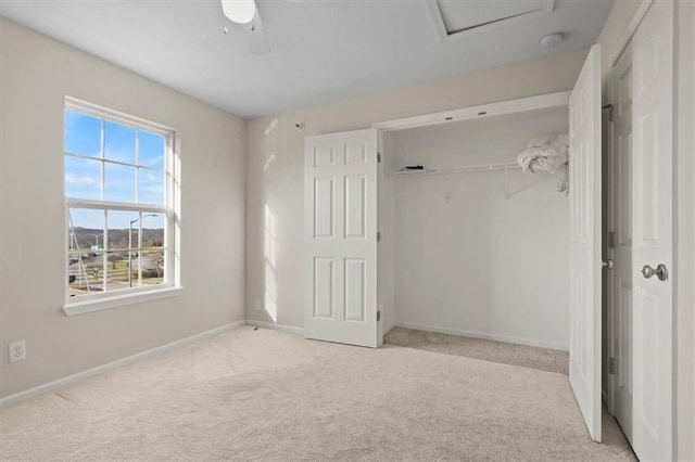 5501 NE 80th Ter Unit 3A, Kansas City, MO 64119 - unfurnished bedroom featuring carpet floors, a closet, baseboards, attic access, and ceiling fan