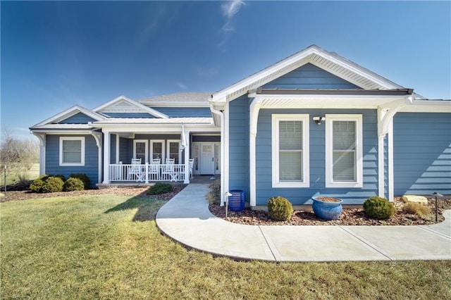 view of front of home with a porch and a front lawn