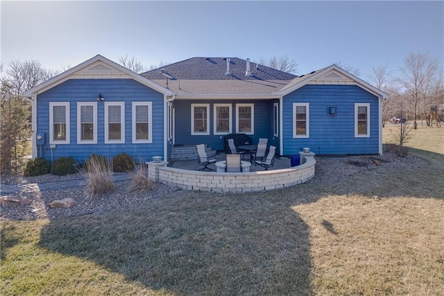 back of house with a patio area, a lawn, and roof with shingles