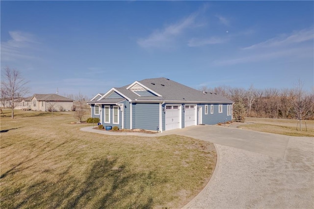 view of front of property with driveway, an attached garage, and a front yard