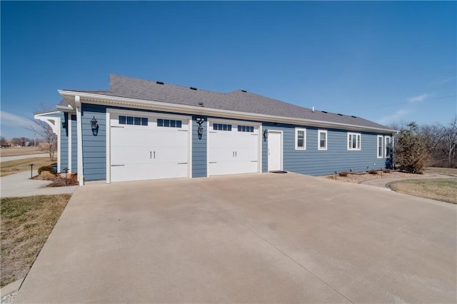 single story home with driveway and a shingled roof