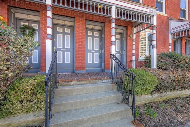 doorway to property with brick siding