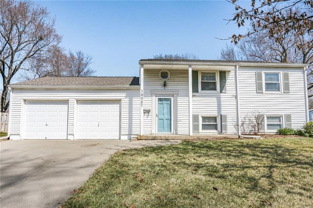 view of front of house with an attached garage, concrete driveway, and a front lawn