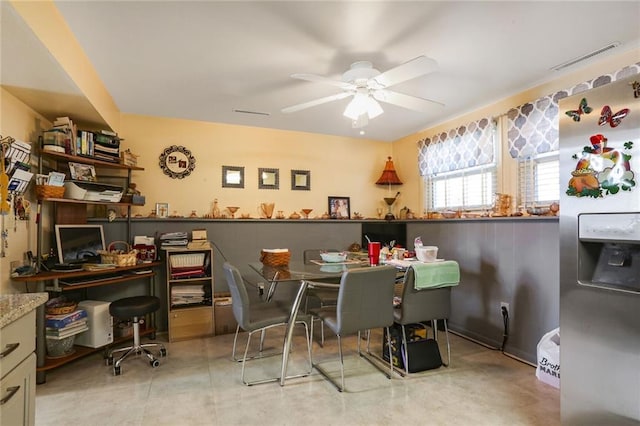 tiled dining space with visible vents and a ceiling fan