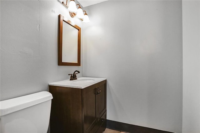 half bathroom with vanity and toilet