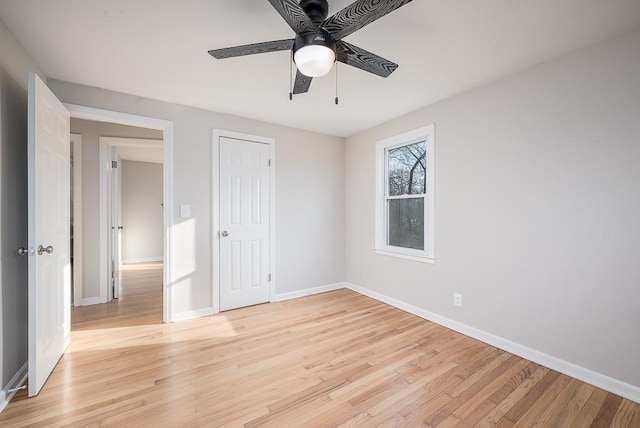 unfurnished bedroom featuring light wood-style floors, baseboards, and ceiling fan