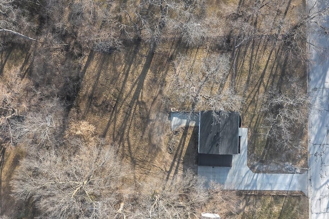 birds eye view of property featuring a view of trees