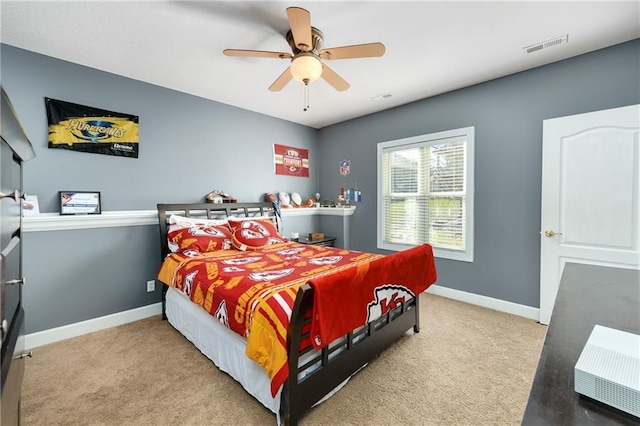 carpeted bedroom featuring visible vents, a ceiling fan, and baseboards