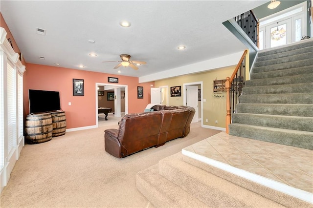 carpeted living room featuring a ceiling fan, baseboards, visible vents, recessed lighting, and stairs