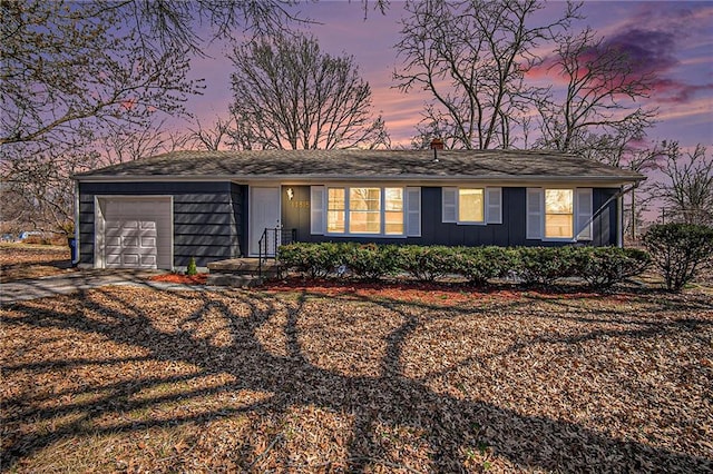 ranch-style home featuring a garage, board and batten siding, and dirt driveway