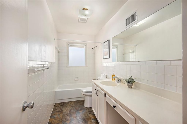 bathroom with visible vents, toilet, tile walls, and vanity