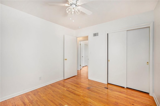 unfurnished bedroom with visible vents, ceiling fan, baseboards, and light wood-style floors