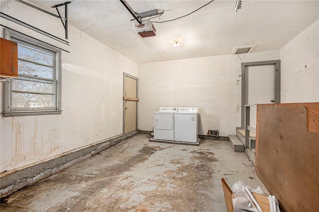 garage with washing machine and clothes dryer and a garage door opener