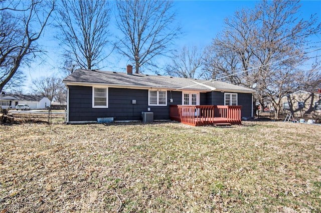 back of property with a lawn, cooling unit, a chimney, and a deck