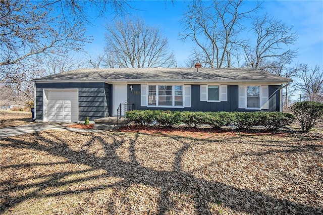 ranch-style home with an attached garage, board and batten siding, and driveway