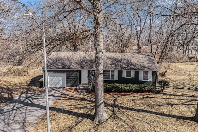 view of front facade with concrete driveway and an attached garage