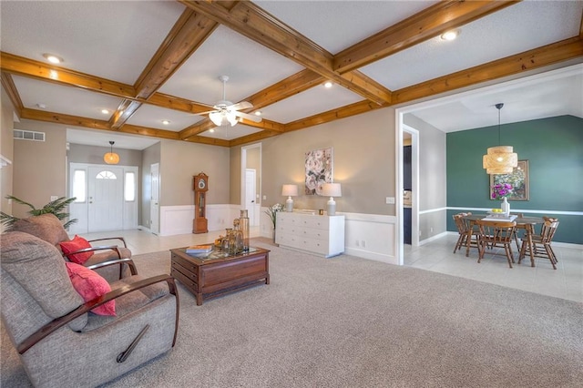 carpeted living room featuring visible vents, beam ceiling, coffered ceiling, wainscoting, and ceiling fan