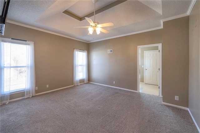 empty room with crown molding, baseboards, carpet floors, and a textured ceiling