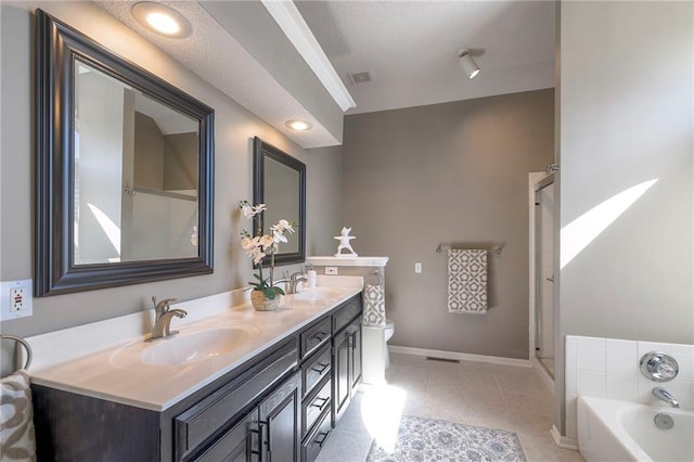 full bath with a bath, double vanity, baseboards, and a sink