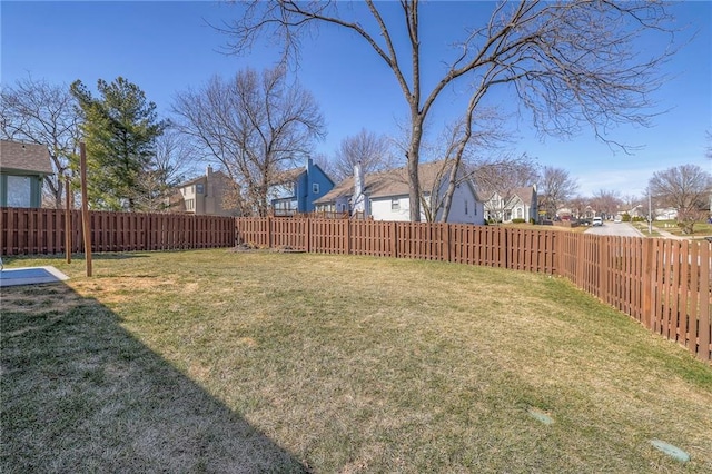 view of yard featuring a residential view and a fenced backyard